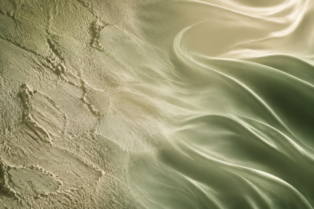 Abstract split composition of rough dry texture transforming into smooth silky luminous texture